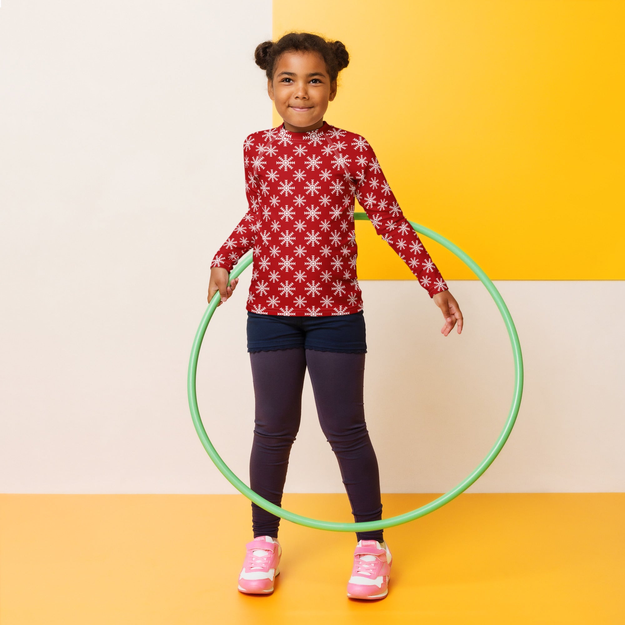 Green plastic hula hoop paired with kids red christmas snowflake long sleeve rash guard swim shirt with upf 50 plus