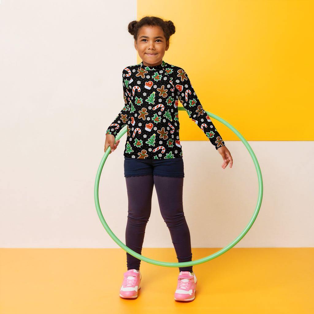 Kids black long sleeve rash guard swim shirt with upf 50 plus and a green plastic hula hoop in the background