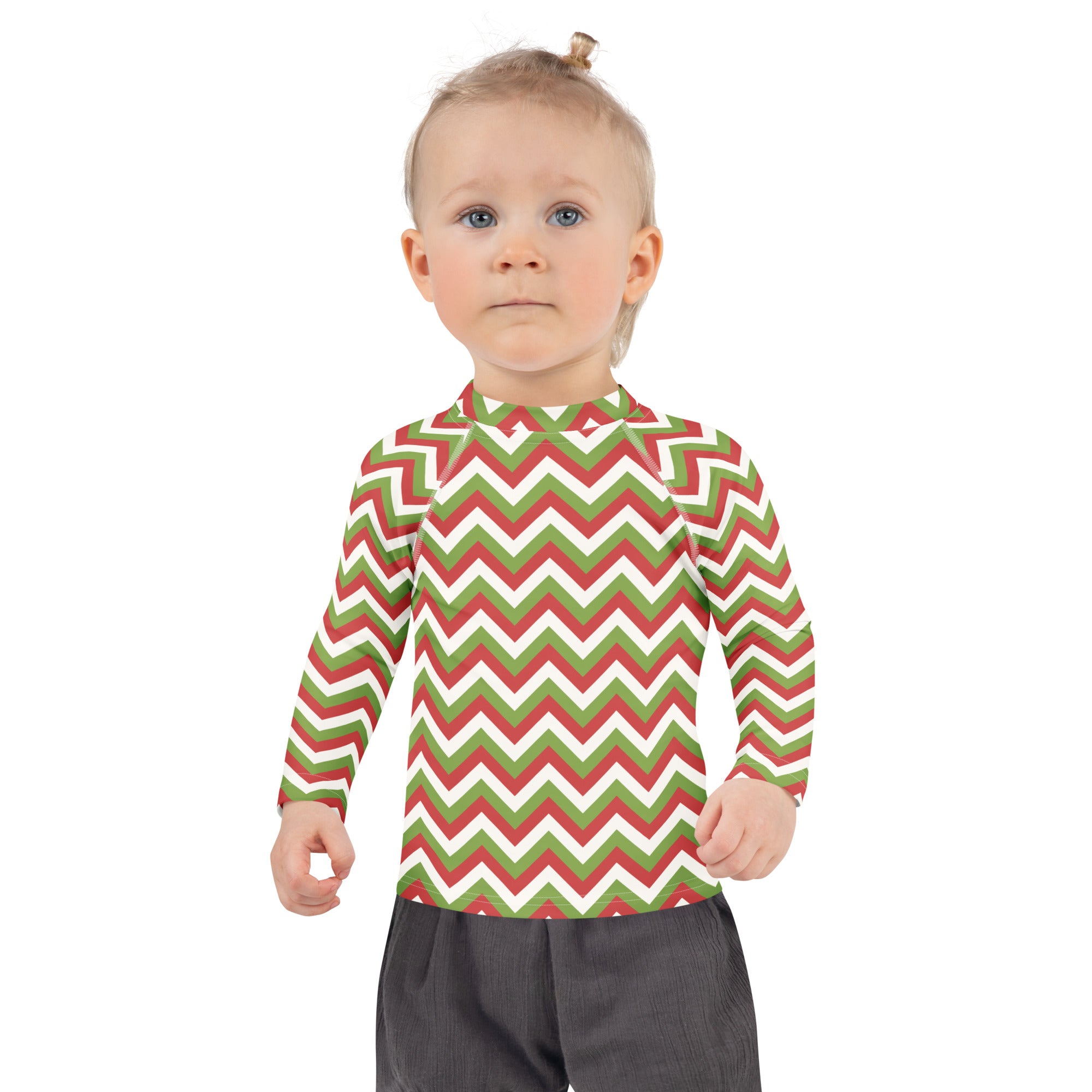 A child wearing a kids red and green chevron Christmas long sleeve rash guard swim shirt with UPF 50 plus protection