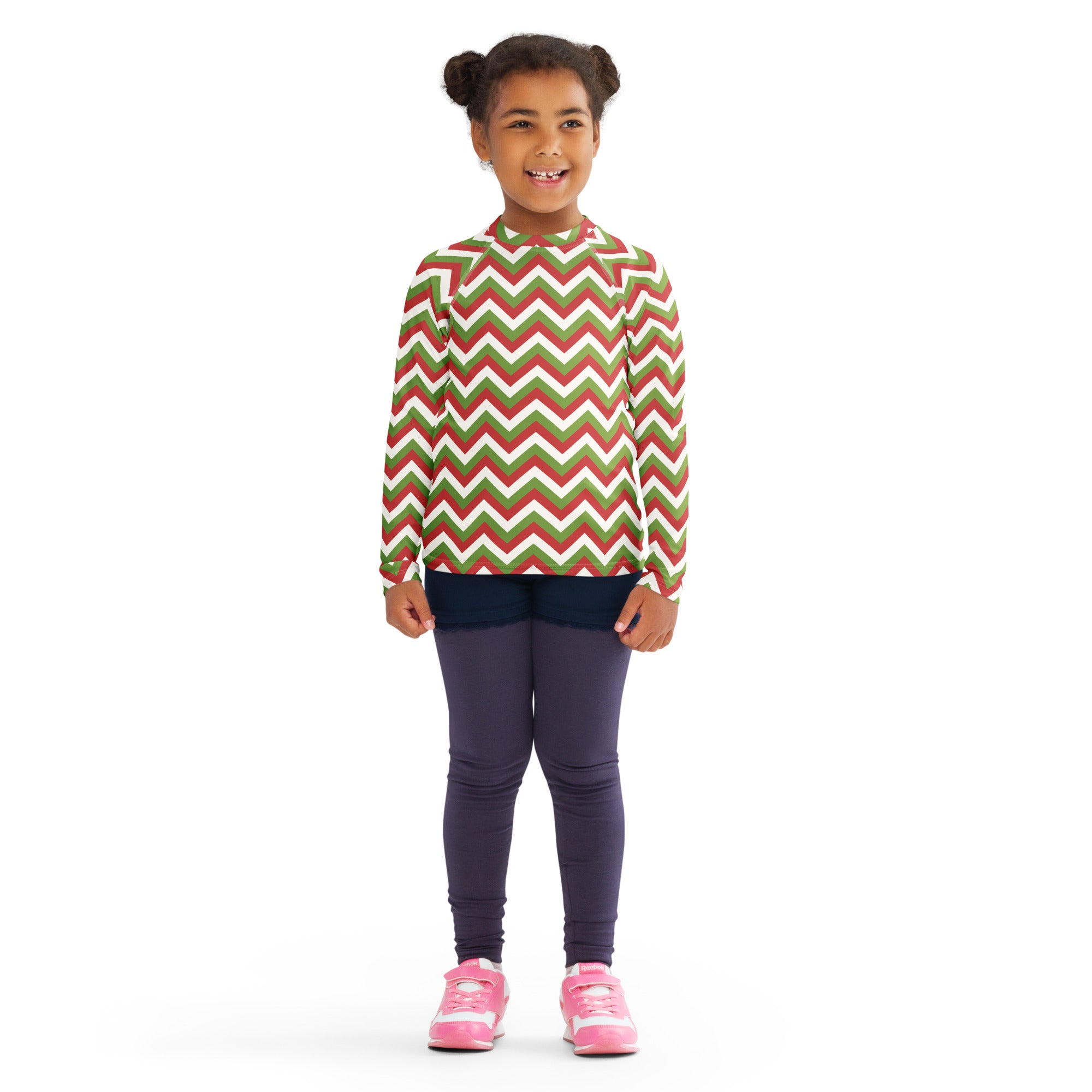 A child wearing a kids red and green chevron christmas long sleeve rash guard swim shirt with UPF 50 plus protection