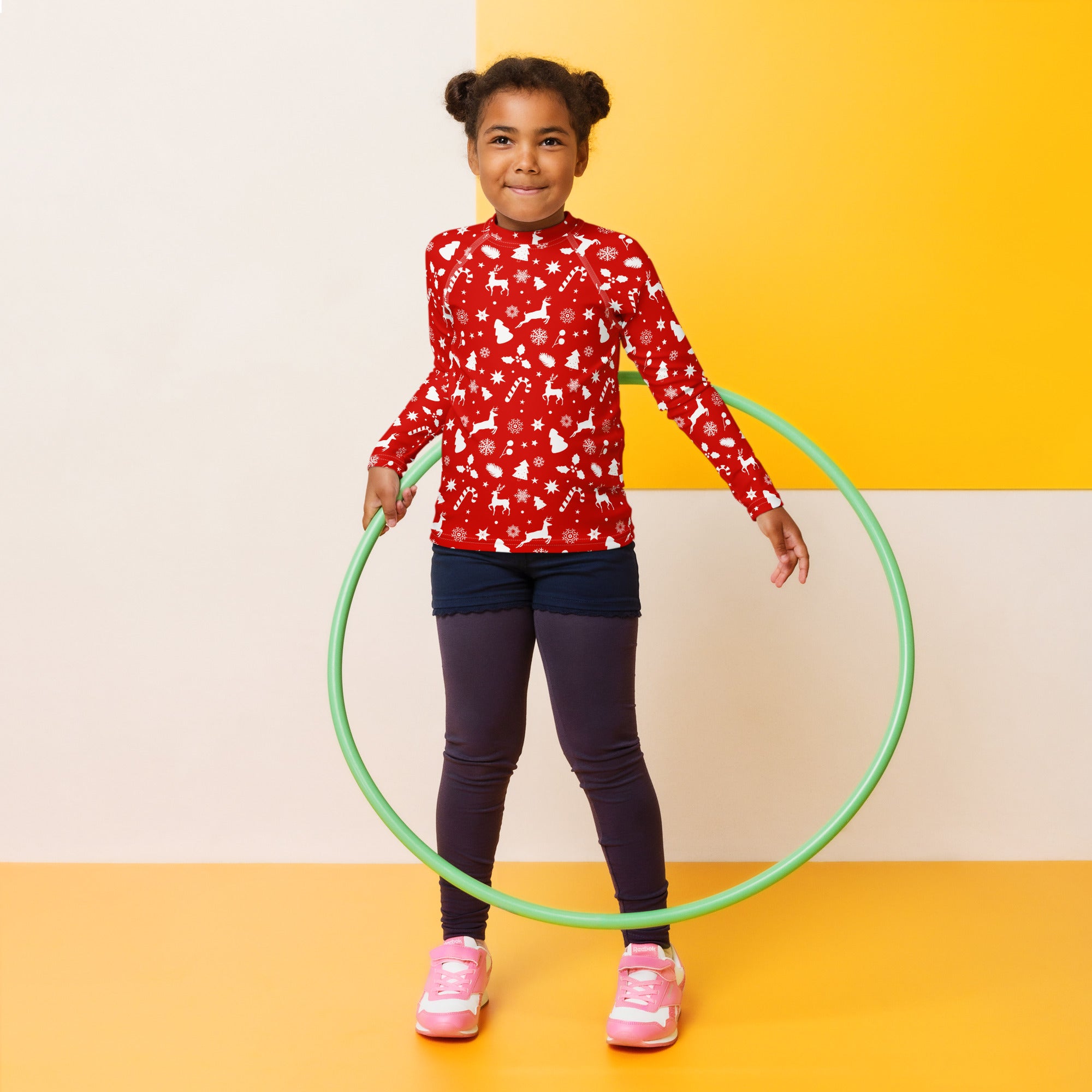 Green plastic hula hoop shown with kids red Christmas long sleeve rash guard swim shirt with UPF 50 plus