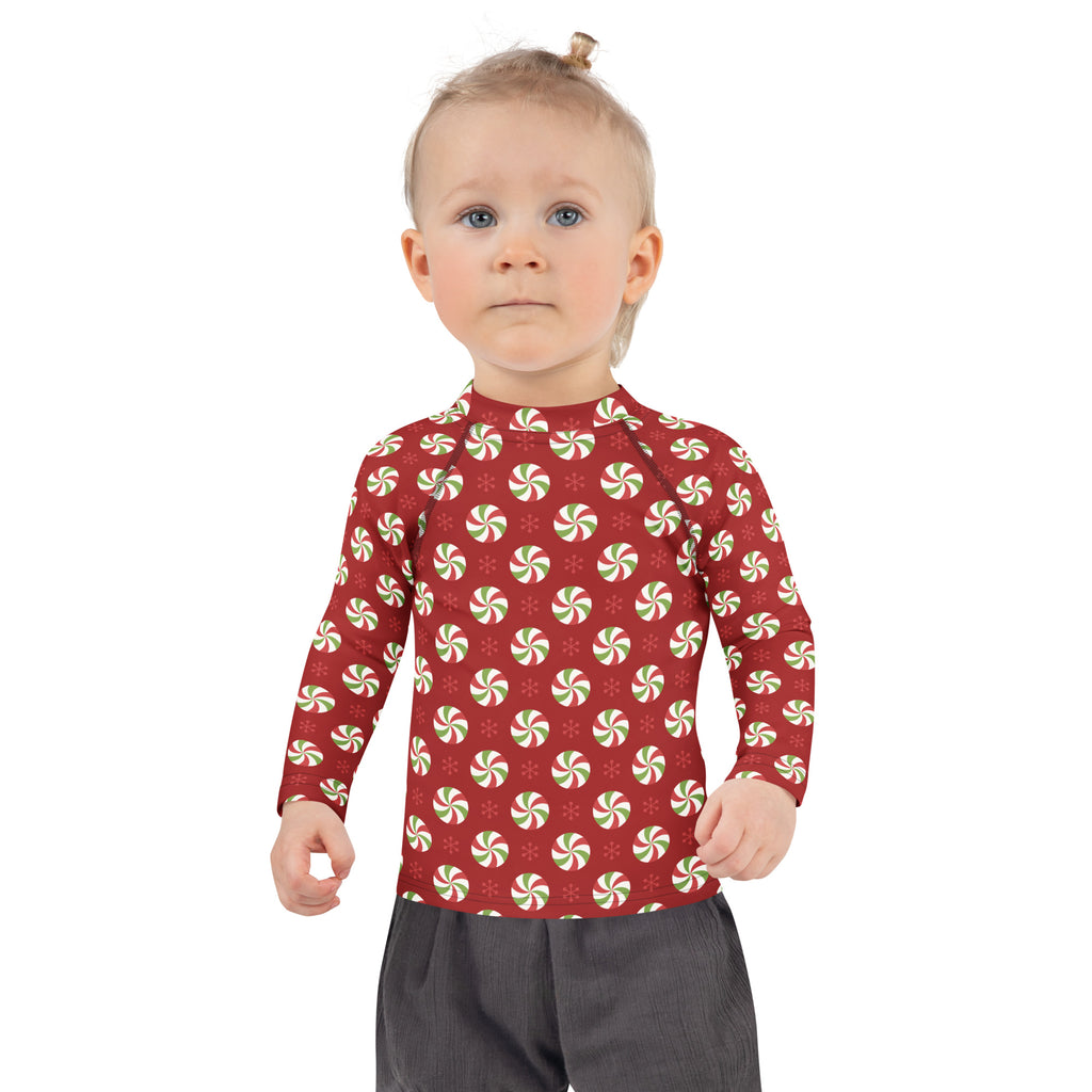Red kids long-sleeved rash guard swim shirt with green and white peppermint pattern and UPF 50 plus sun protection