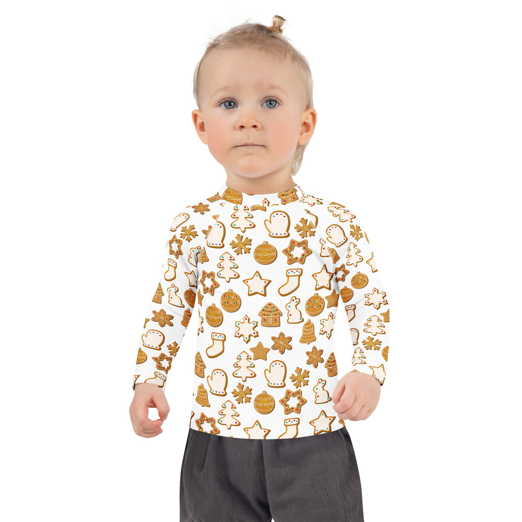A child wearing a white kids christmas gingerbread cookie long sleeve rash guard swim shirt with upf 50+