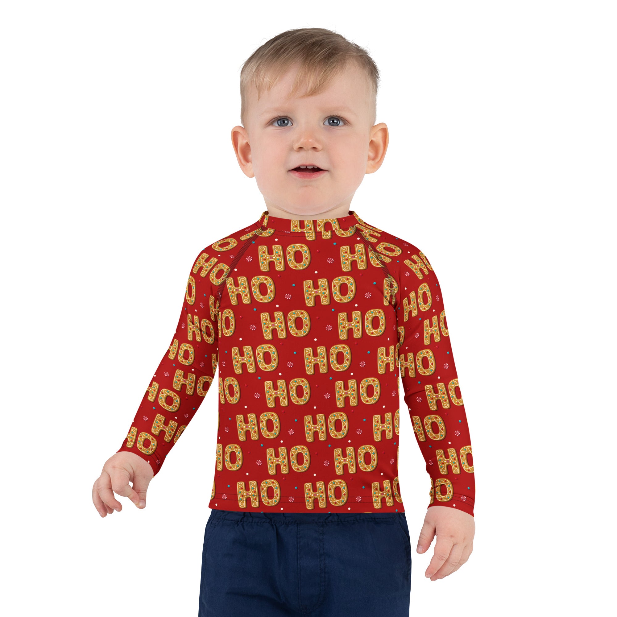 Red long-sleeved kids rash guard with gold and white ho ho pattern, upf 50 plus for sun protection