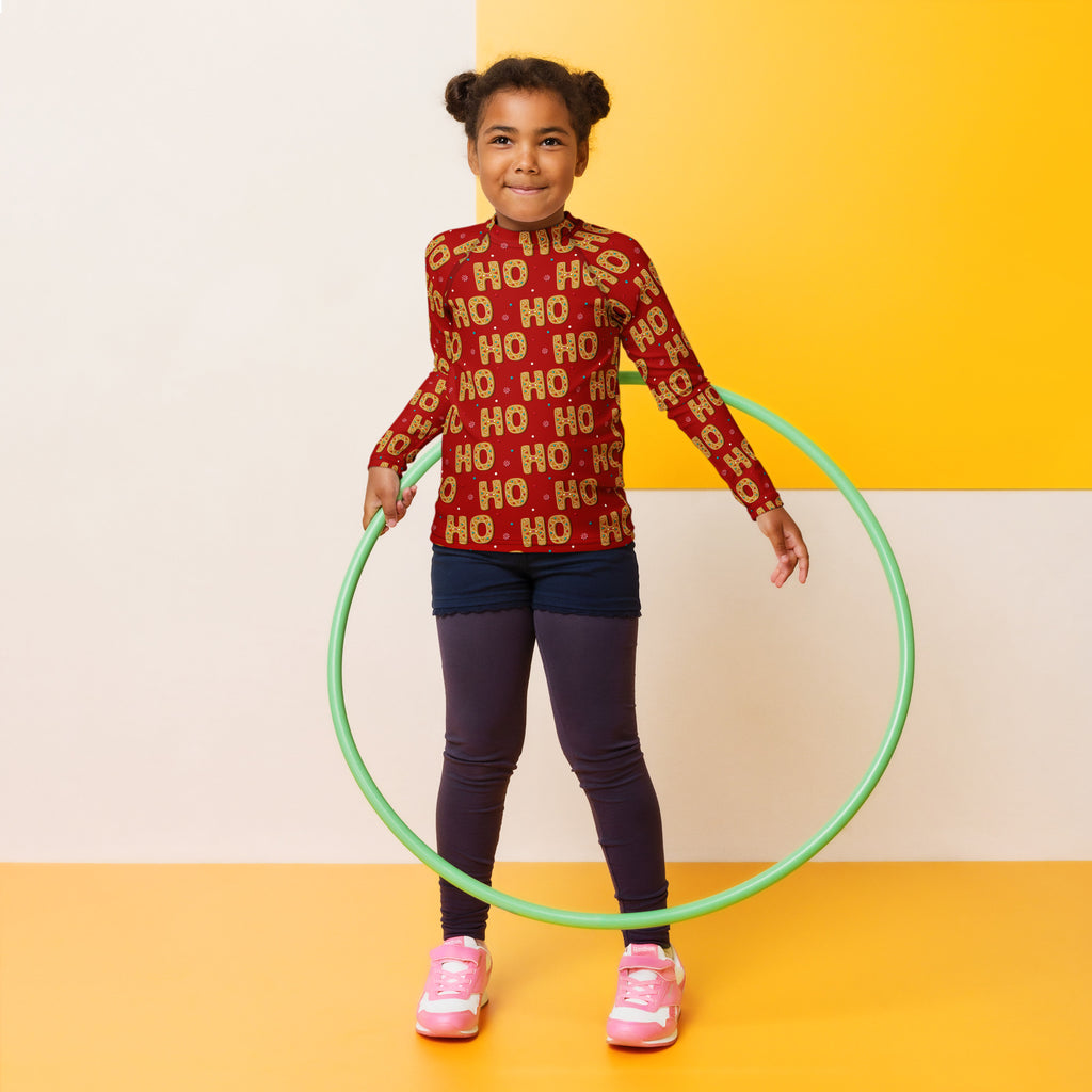 Green plastic hula hoop shown with kids ho ho ho gingerbread christmas long sleeve rash guard swim shirt with upf 50+