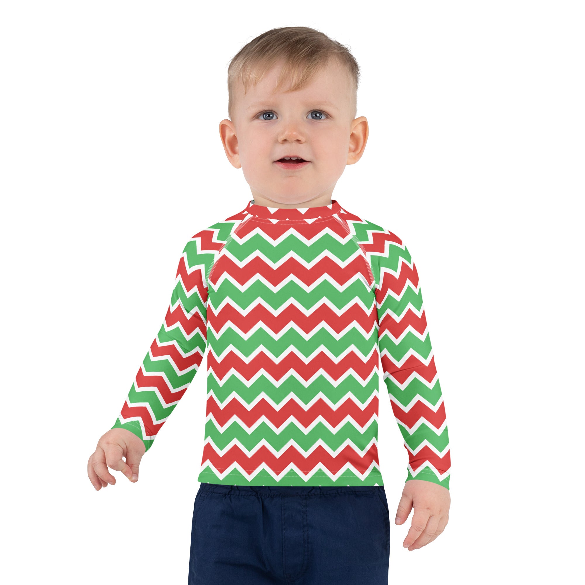 A child wearing a kids christmas chevron long sleeve rash guard swim shirt with upf 50 plus in red green and white