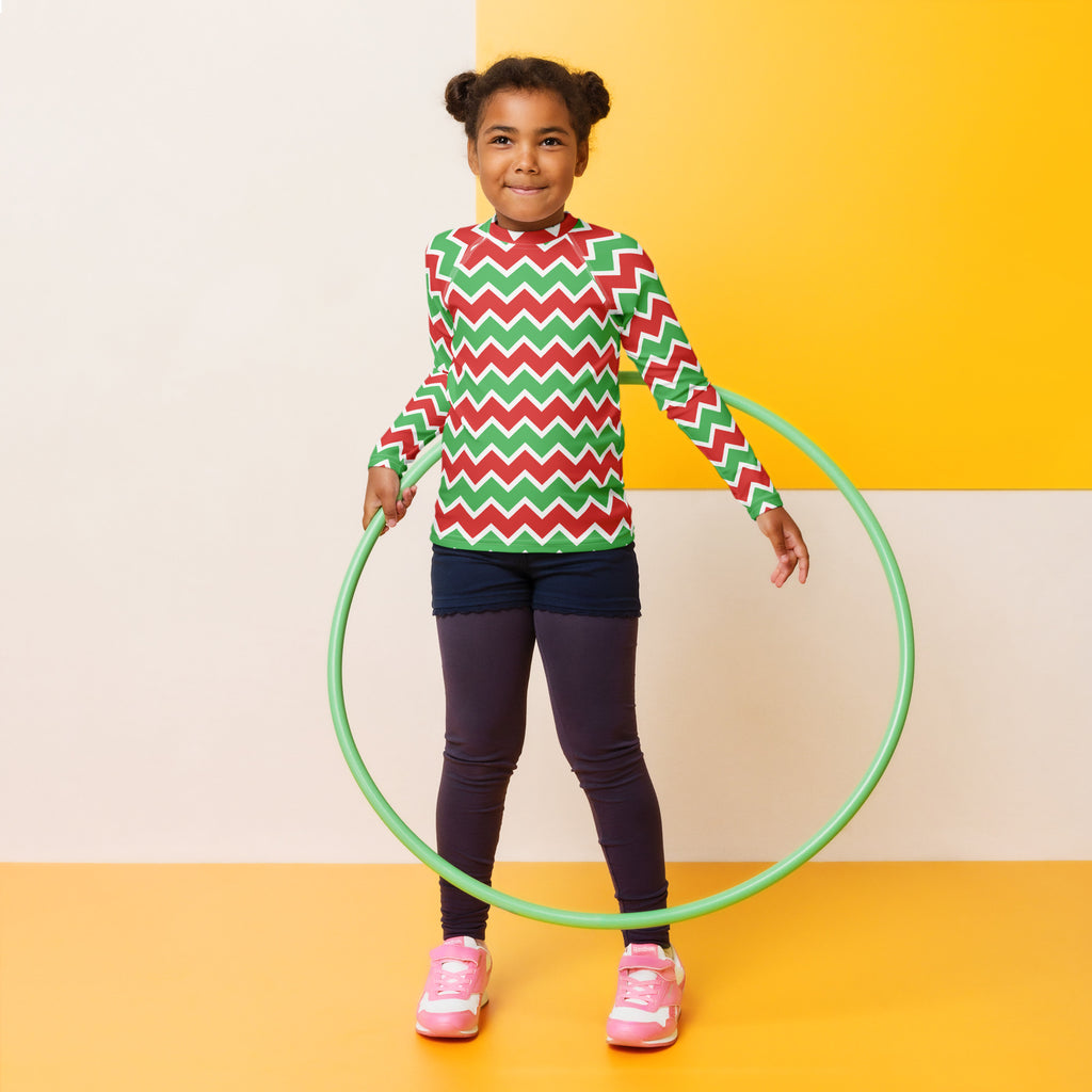 Green plastic hula hoop alongside kids christmas chevron long sleeve rash guard swim shirt with upf 50 plus
