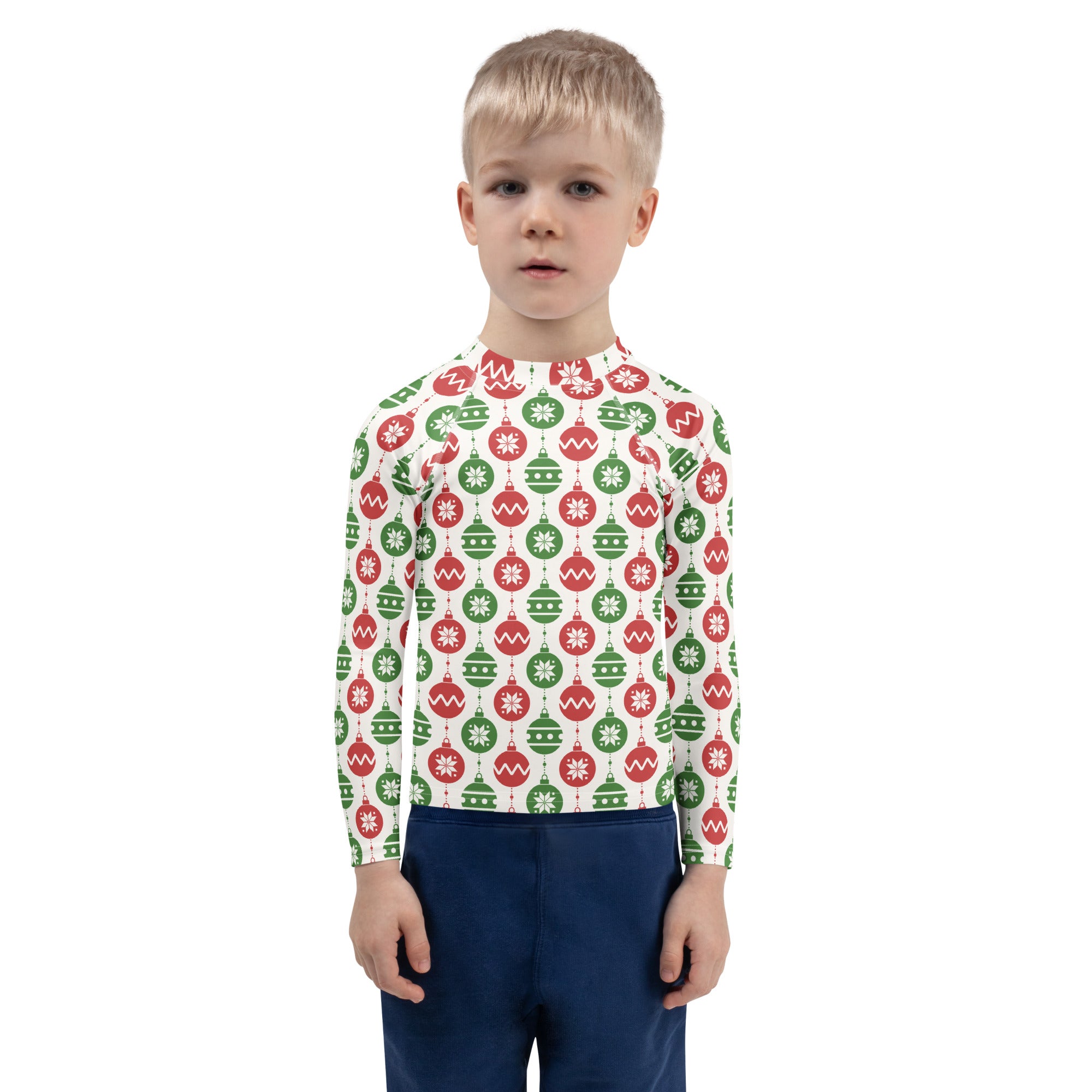 A child wearing a white long sleeve kids rash guard with red and green christmas ornament patterns and UPF 50+ protection