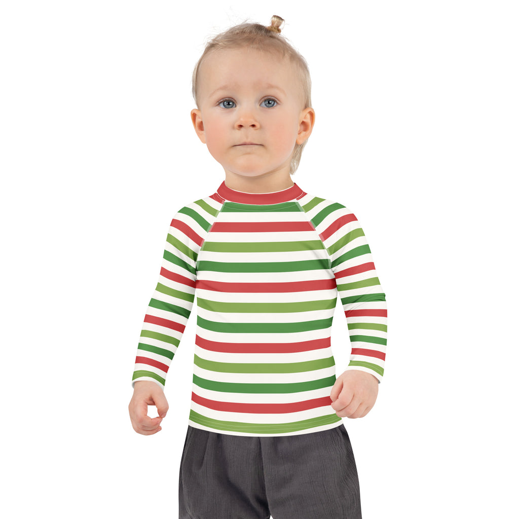 A child wearing a kids red and green christmas stripes long sleeve rash guard swim shirt with UPF 50+