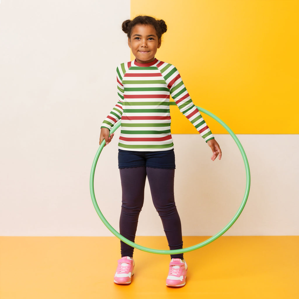 Green plastic hula hoop shown with kids red and green christmas stripes long sleeve rash guard swim shirt with upf 50+