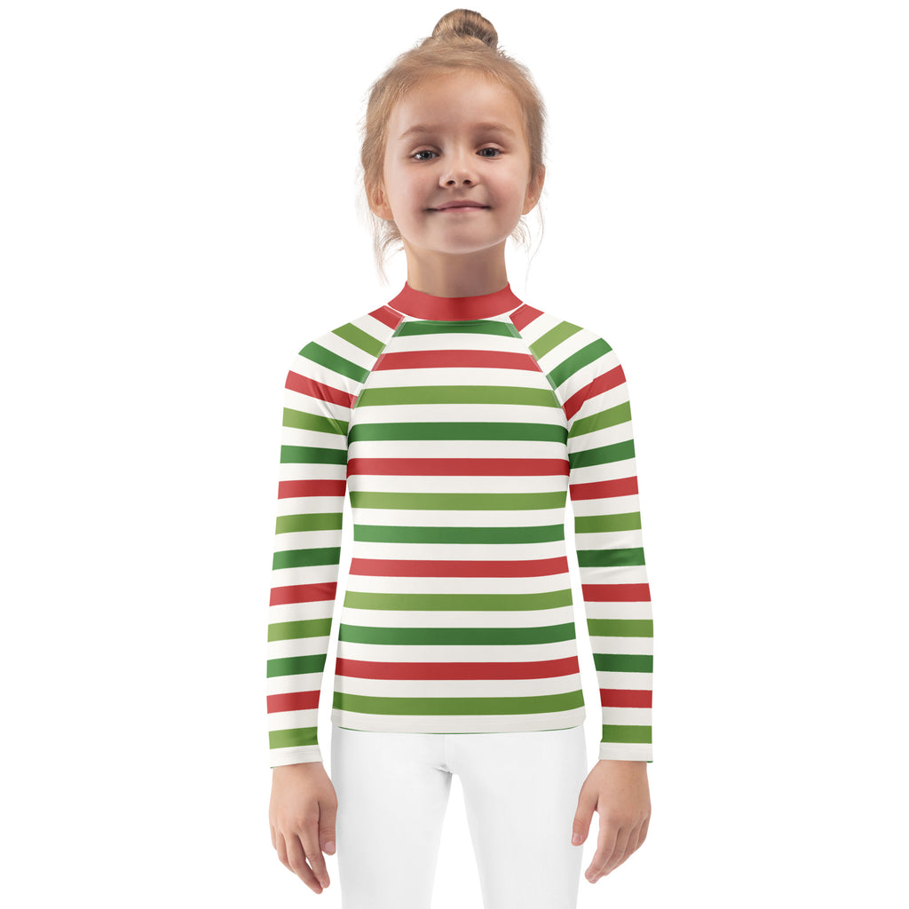 A child wearing a kids red and green Christmas stripes long sleeve rash guard swim shirt with UPF 50 plus protection