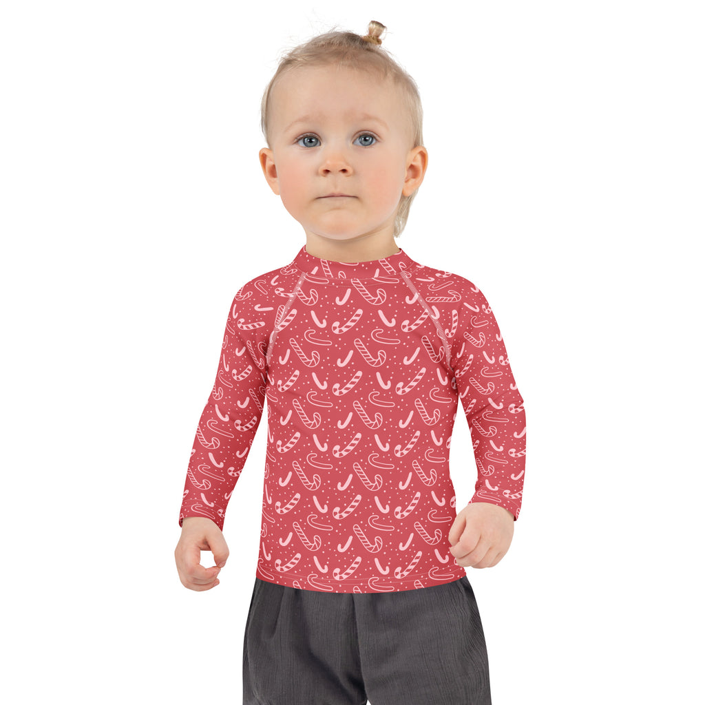 Kids red long sleeve rash guard swim shirt with white candy cane pattern and upf 50 plus sun protection