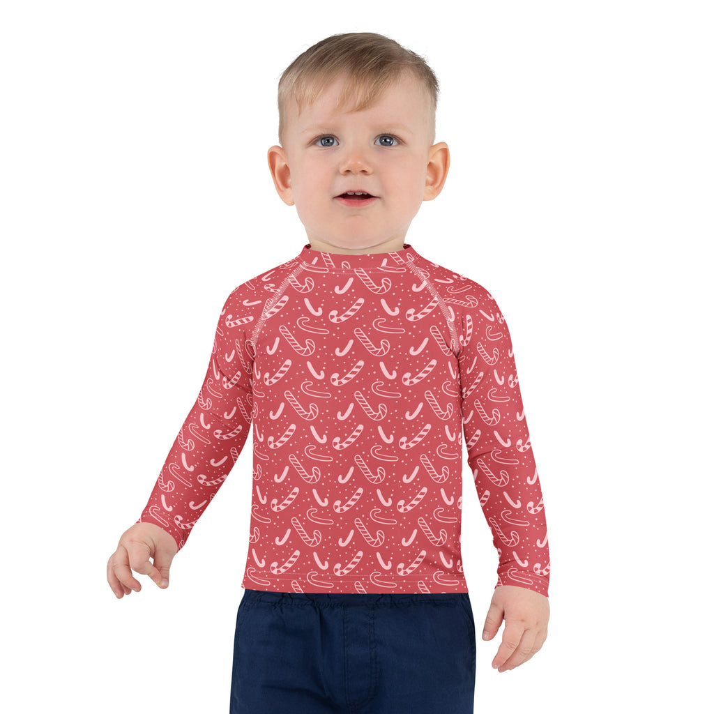 Kids red long sleeve rash guard swim shirt with white candy cane pattern and UPF 50 plus for Christmas protection