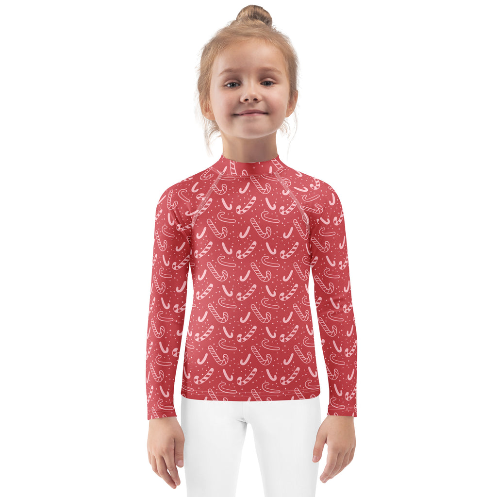 Kids red long sleeve rash guard swim shirt with white candy cane pattern and upf 50 plus protection