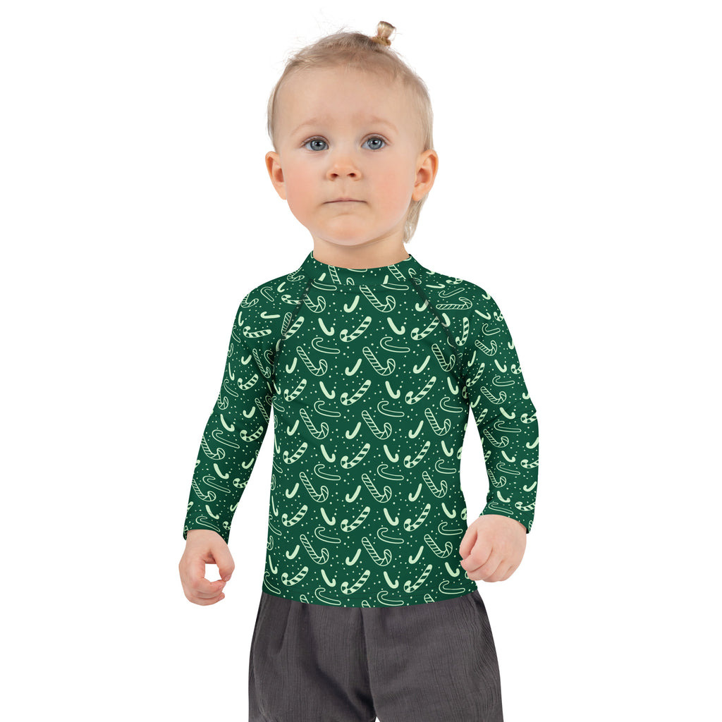 Kids green candy cane christmas long sleeve rash guard swim shirt with upf 50 plus in white pattern design