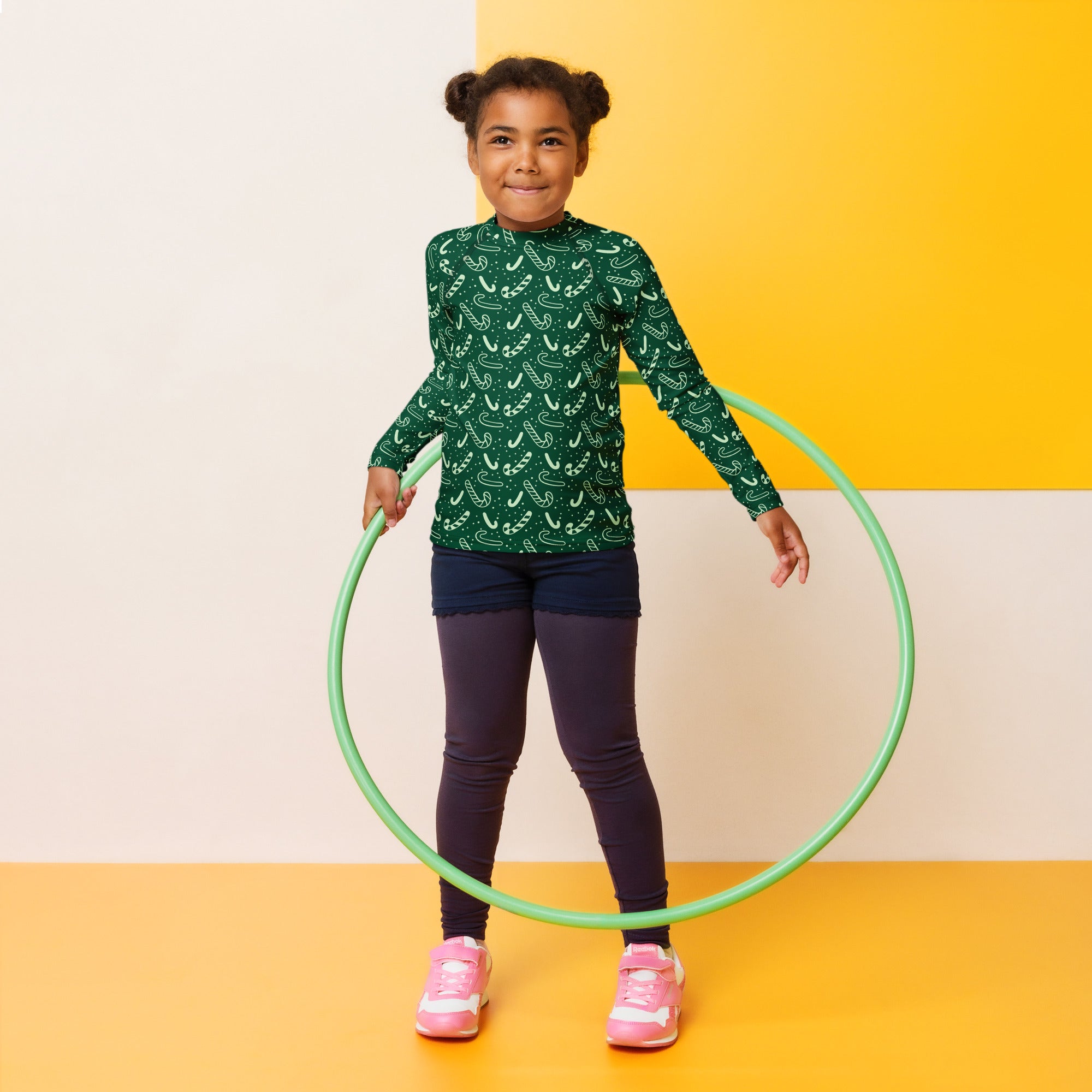 Kids green candy cane christmas long sleeve rash guard swim shirt with upf 50 plus and a green hula hoop