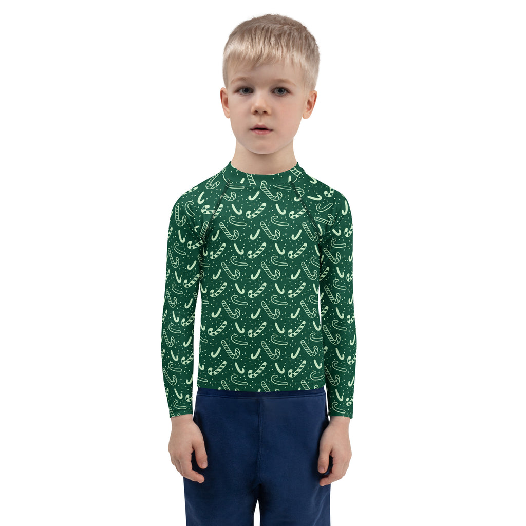 Kids green candy cane christmas rash guard swim shirt with long sleeves and upf 50 plus for sun protection