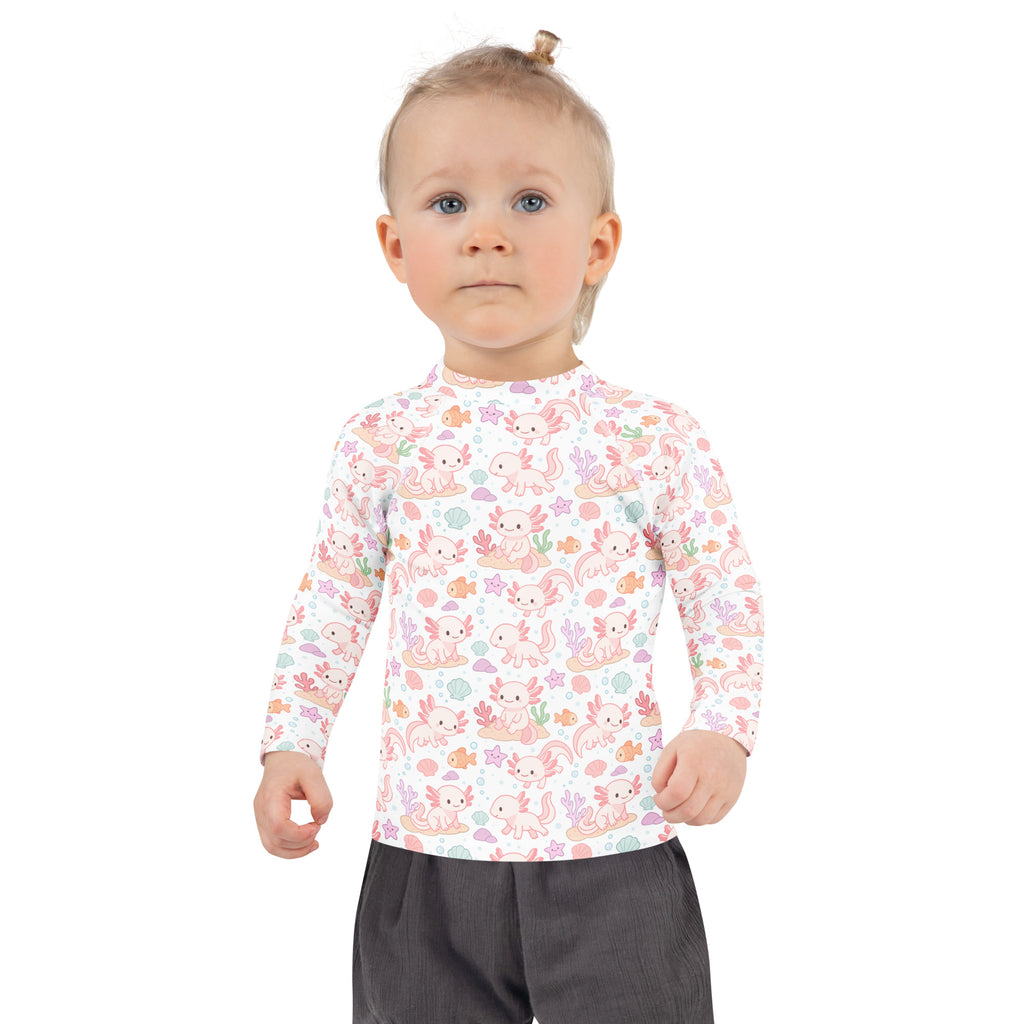 A child wearing a girls axolotl long sleeve rash guard swim shirt with UPF 50 plus in white with pink axolotl pattern