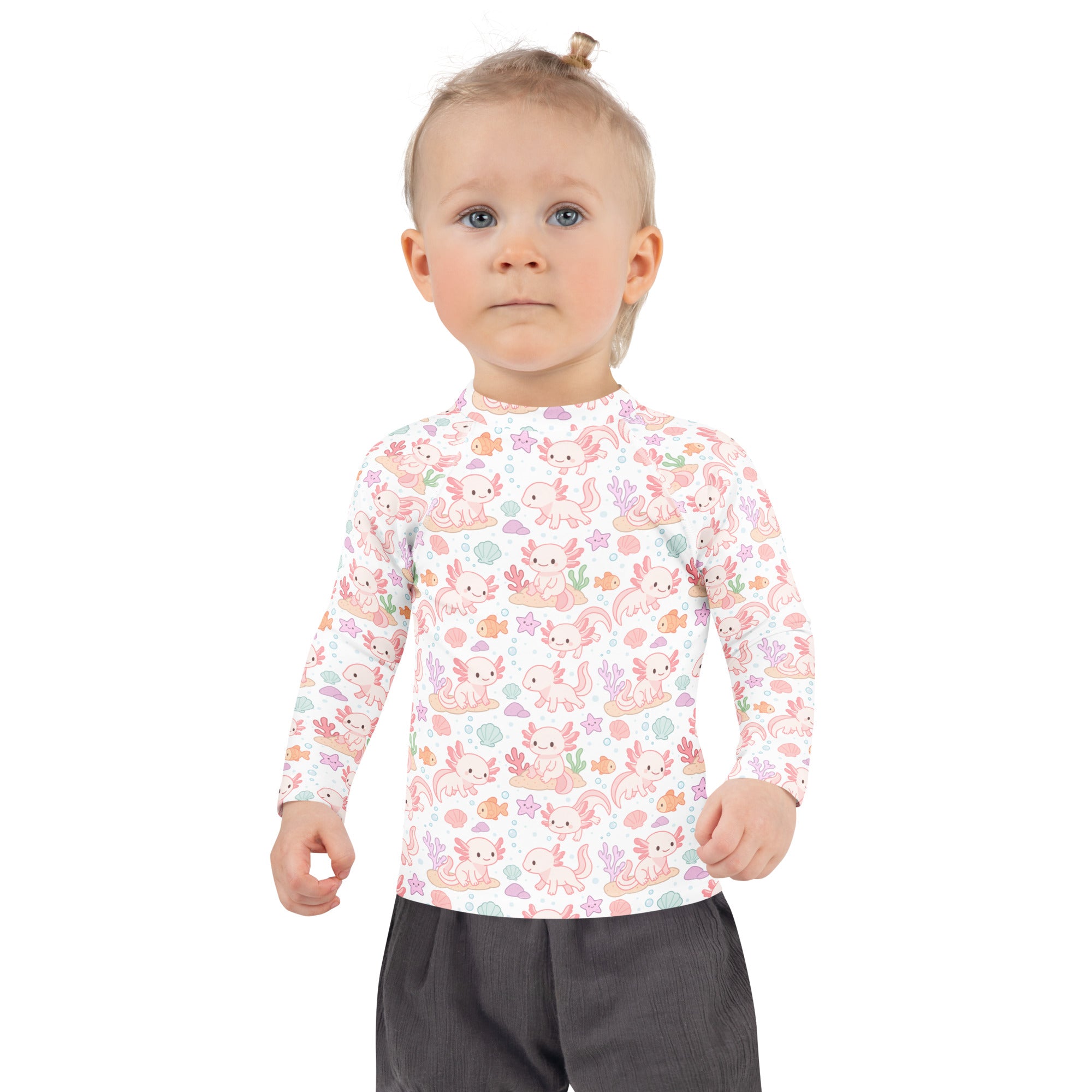 A child wearing a girls axolotl long sleeve rash guard swim shirt with UPF 50 plus in white with pink axolotl pattern