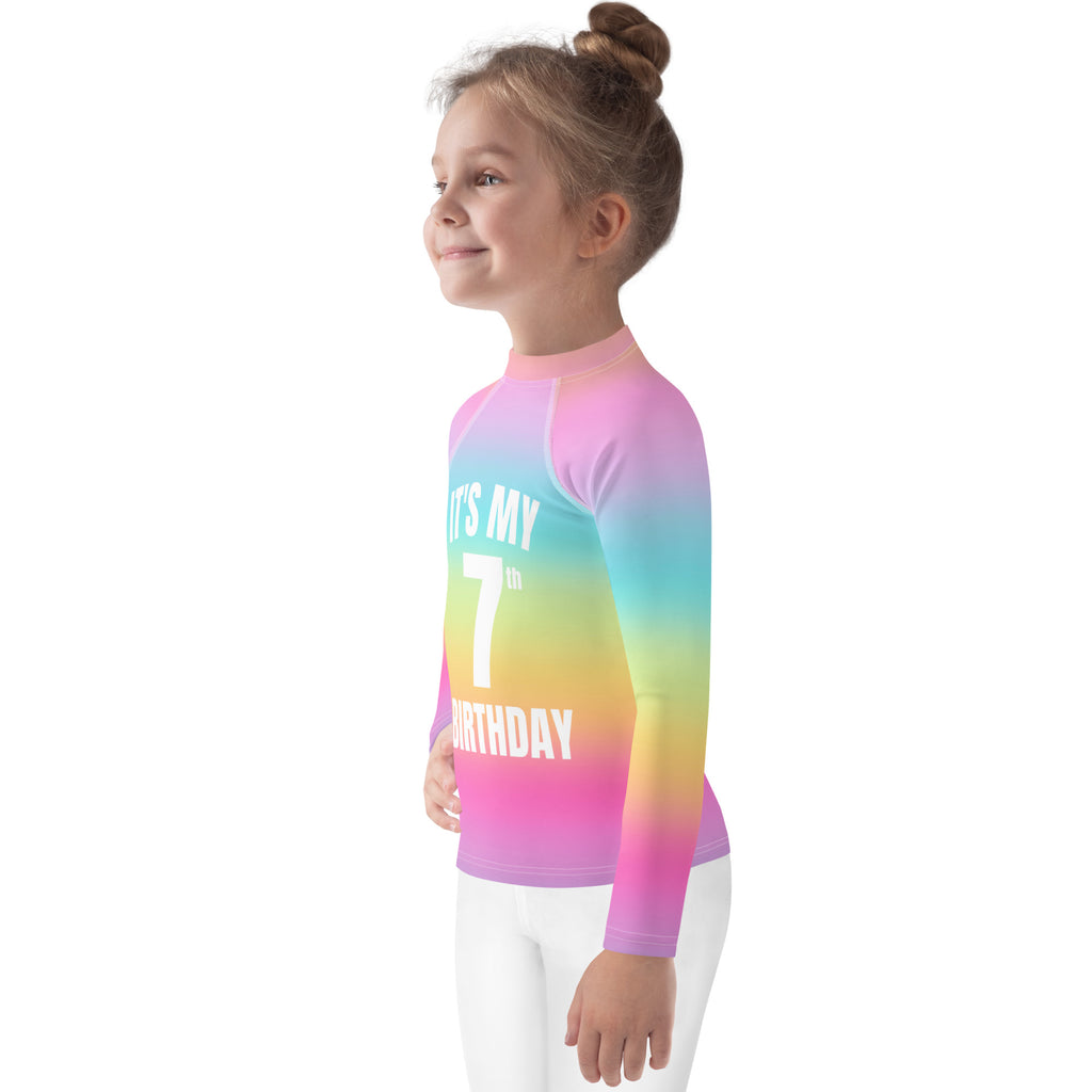 Girls bright rainbow long-sleeved rash guard swim shirt with upf 50 and it’s my 7th birthday printed in white