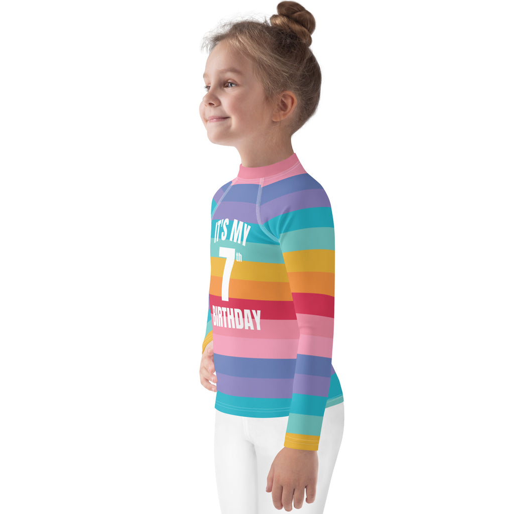 Girls bright striped rainbow long-sleeve rash guard with upf 50 plus and its my 7th birthday text in white