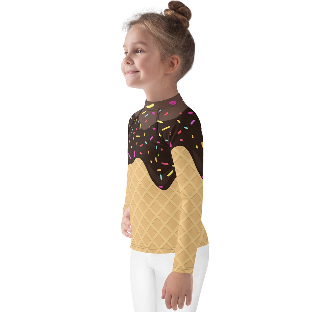 A child wearing a kids chocolate ice cream waffle cone rash guard with sprinkles long sleeve swim shirt with UPF 50+