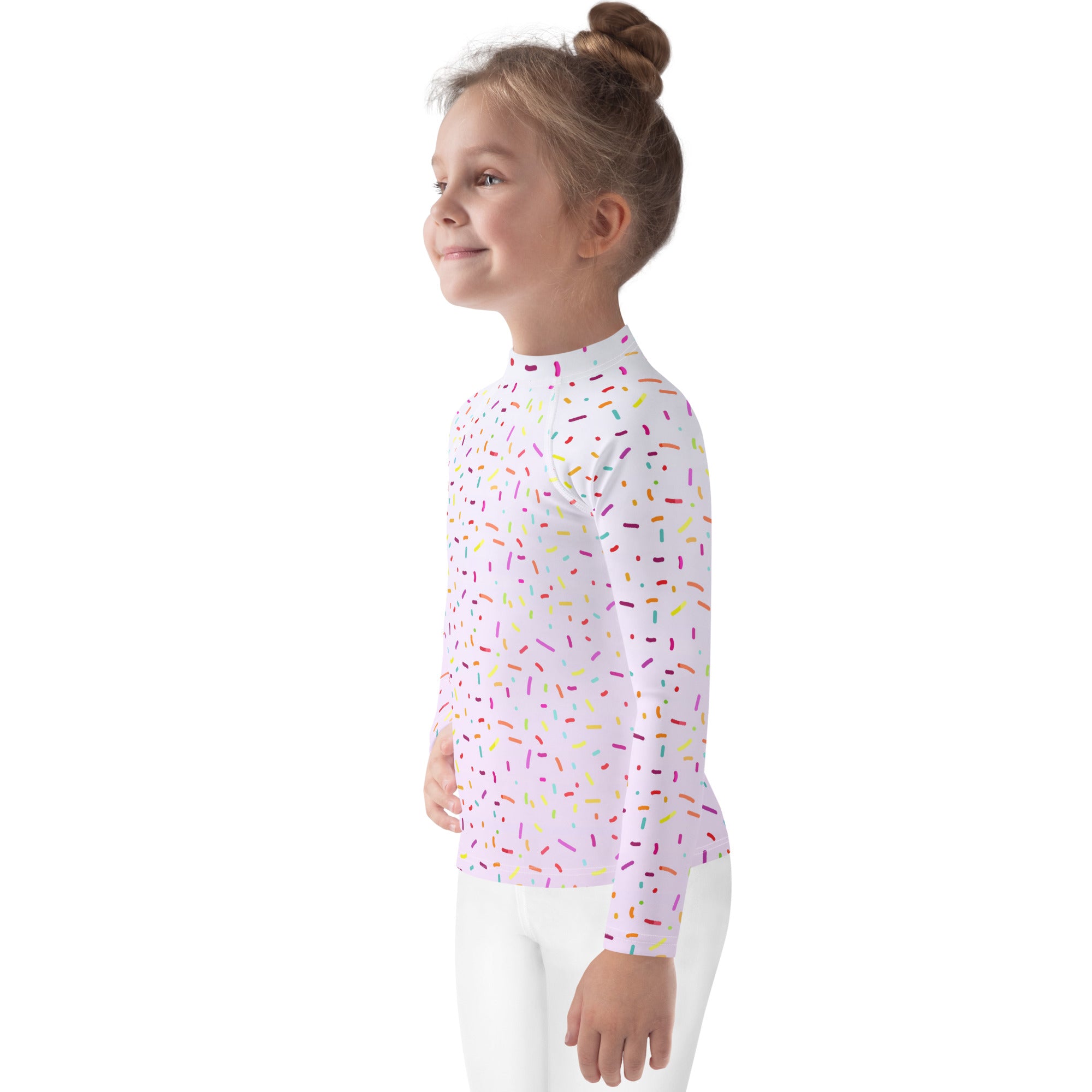 A white kids long sleeve rash guard swim shirt with colorful sprinkles and UPF 50 plus sun protection