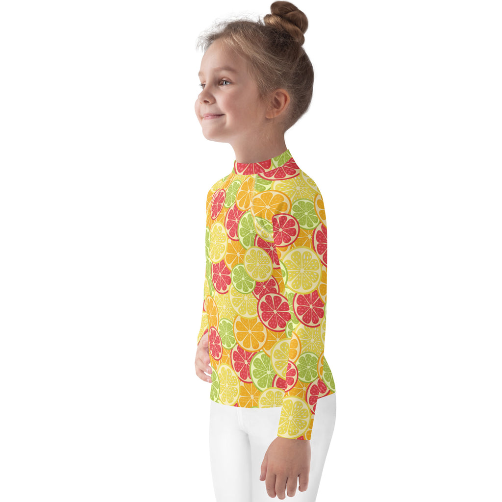 Kids citrus fruit long sleeve rash guard swim shirt in vibrant yellow with colorful sliced citrus pattern and UPF 50+ protection