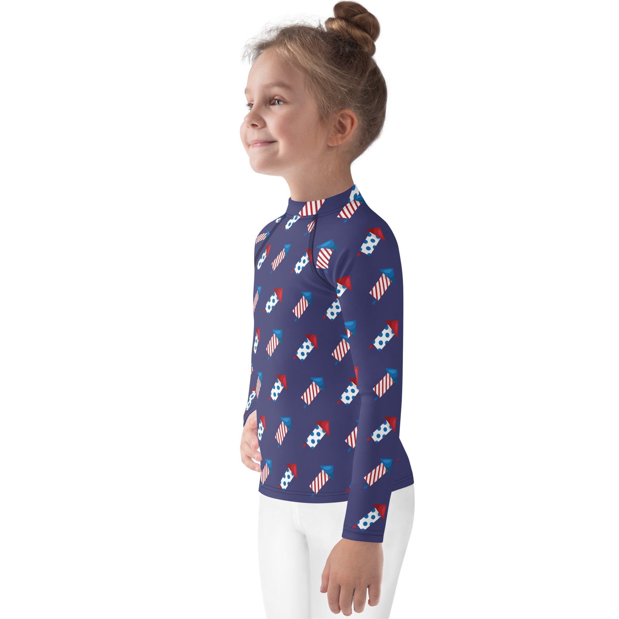 A navy blue kids long sleeve rash guard with red white and blue fireworks pattern and upf 50 plus sun protection