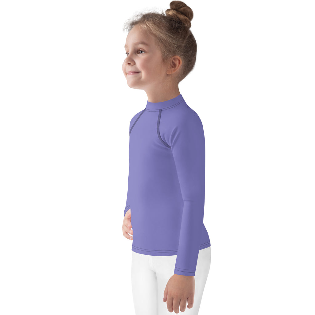 A child wearing a girls purple long sleeve rash guard swim shirt with UPF 50 plus and a high collar