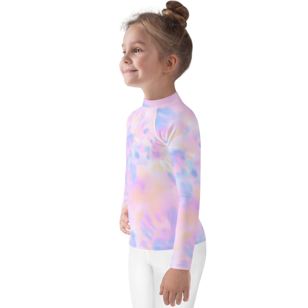 A child wearing a girls pastel watercolor long sleeve rash guard swim shirt with UPF 50 plus in soft pastel tie dye