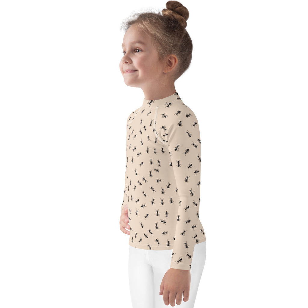 Beige long sleeve kids rash guard swim shirt with black ant pattern and UPF 50 plus sun protection