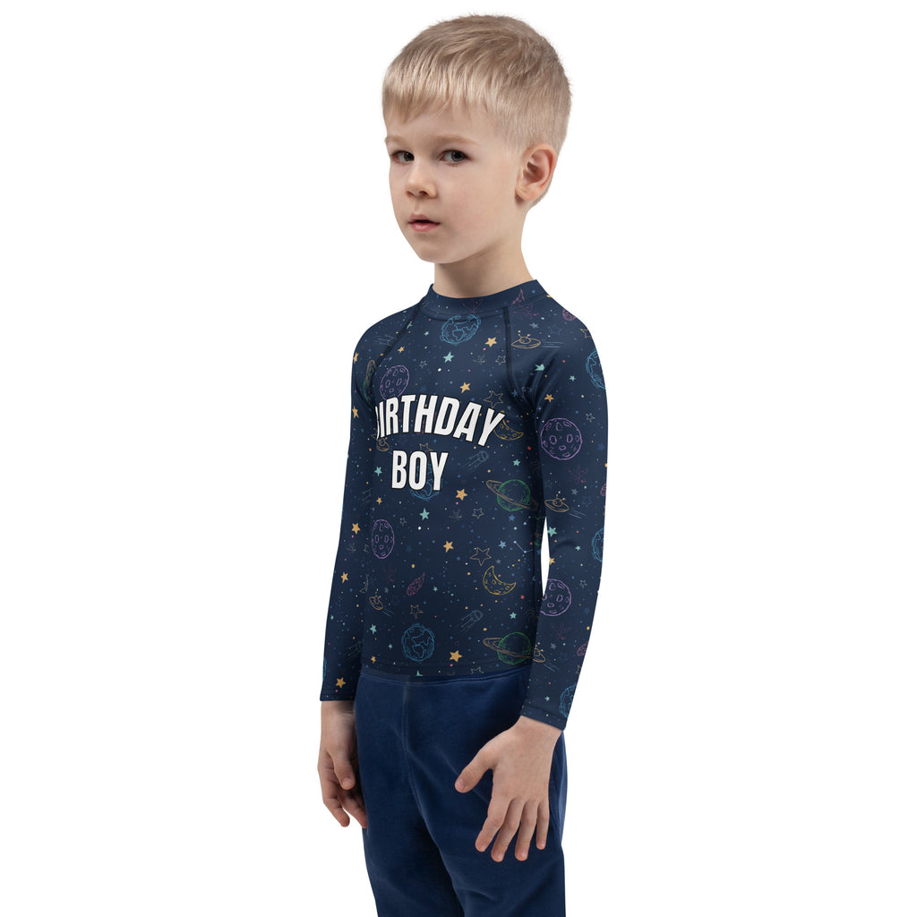 Navy blue long sleeve rash guard with colorful galaxy space print featuring planets stars and moons with upf 50+ protection