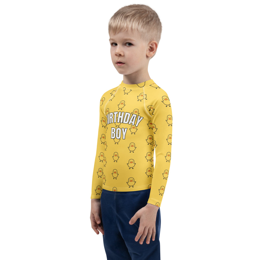 Yellow long sleeve rash guard swim shirt with cartoon ducks and birthday boy text offering upf 50 plus protection