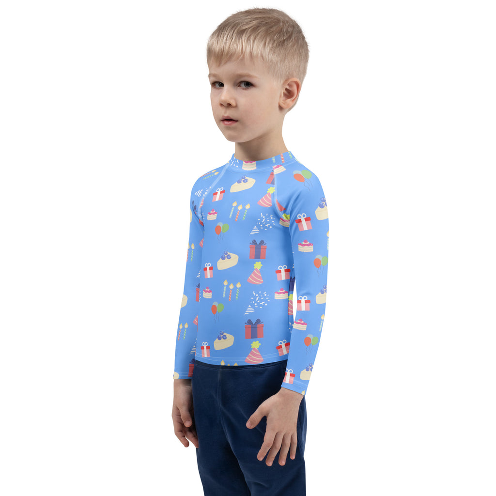 Kids blue long sleeve rash guard swim shirt with playful birthday cakes, gifts, party hats and upf 50 plus protection
