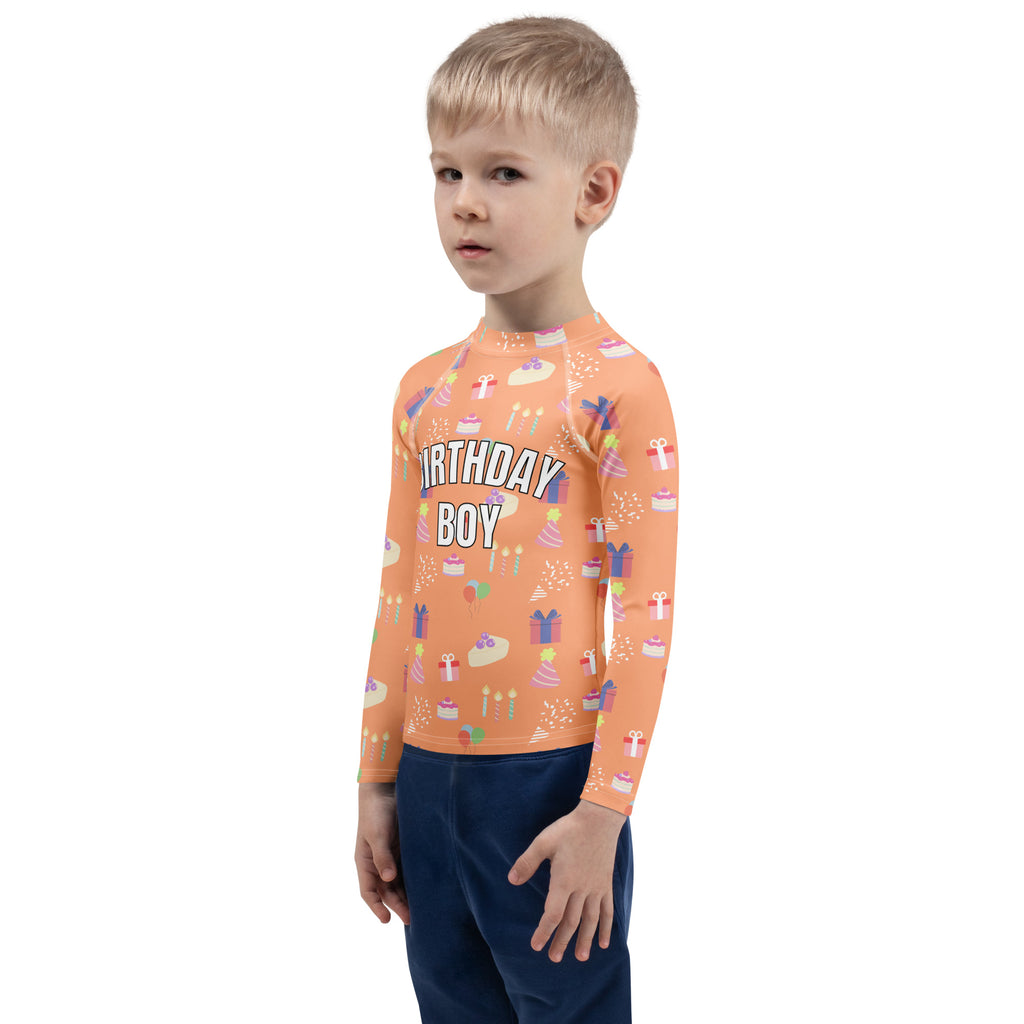 Orange long sleeve rash guard swim shirt with birthday boy text and cake, gift, and candle pattern with UPF 50+ protection