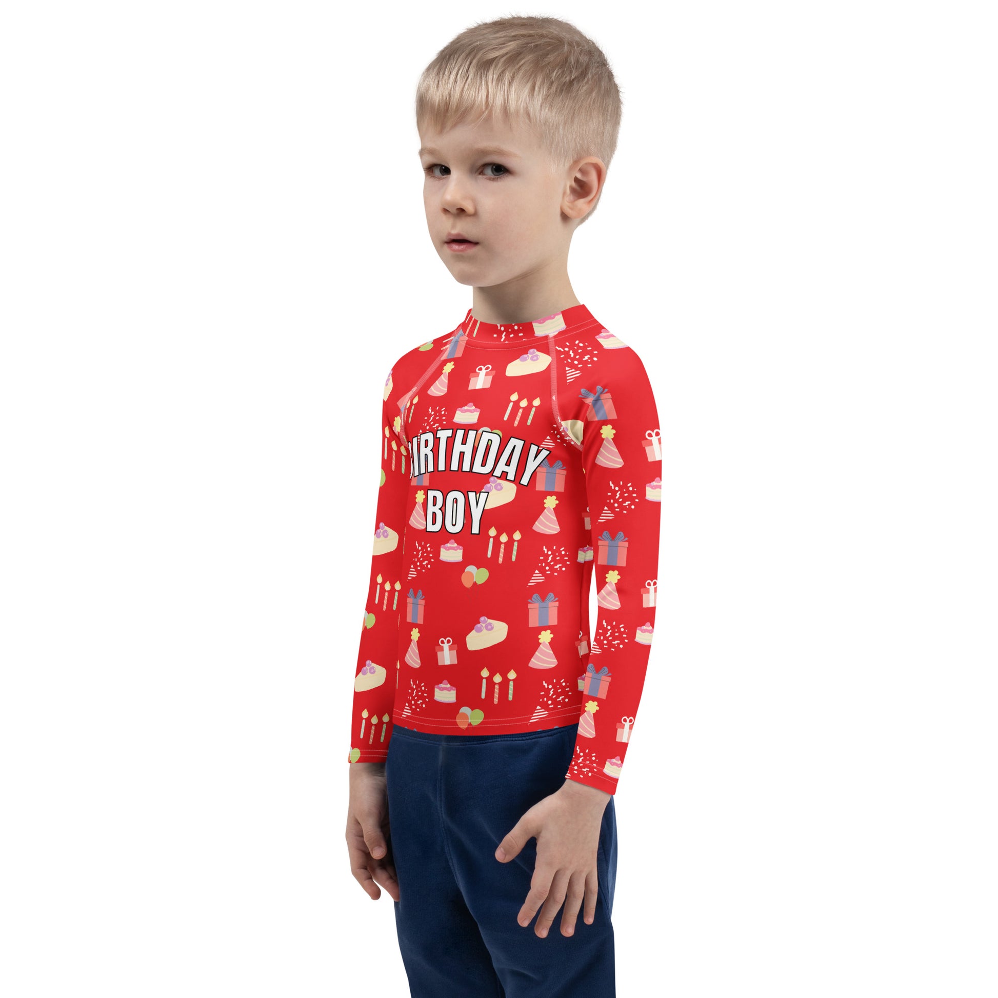 Child wearing a red 'Birthday Boy' shirt with patterns on a white background