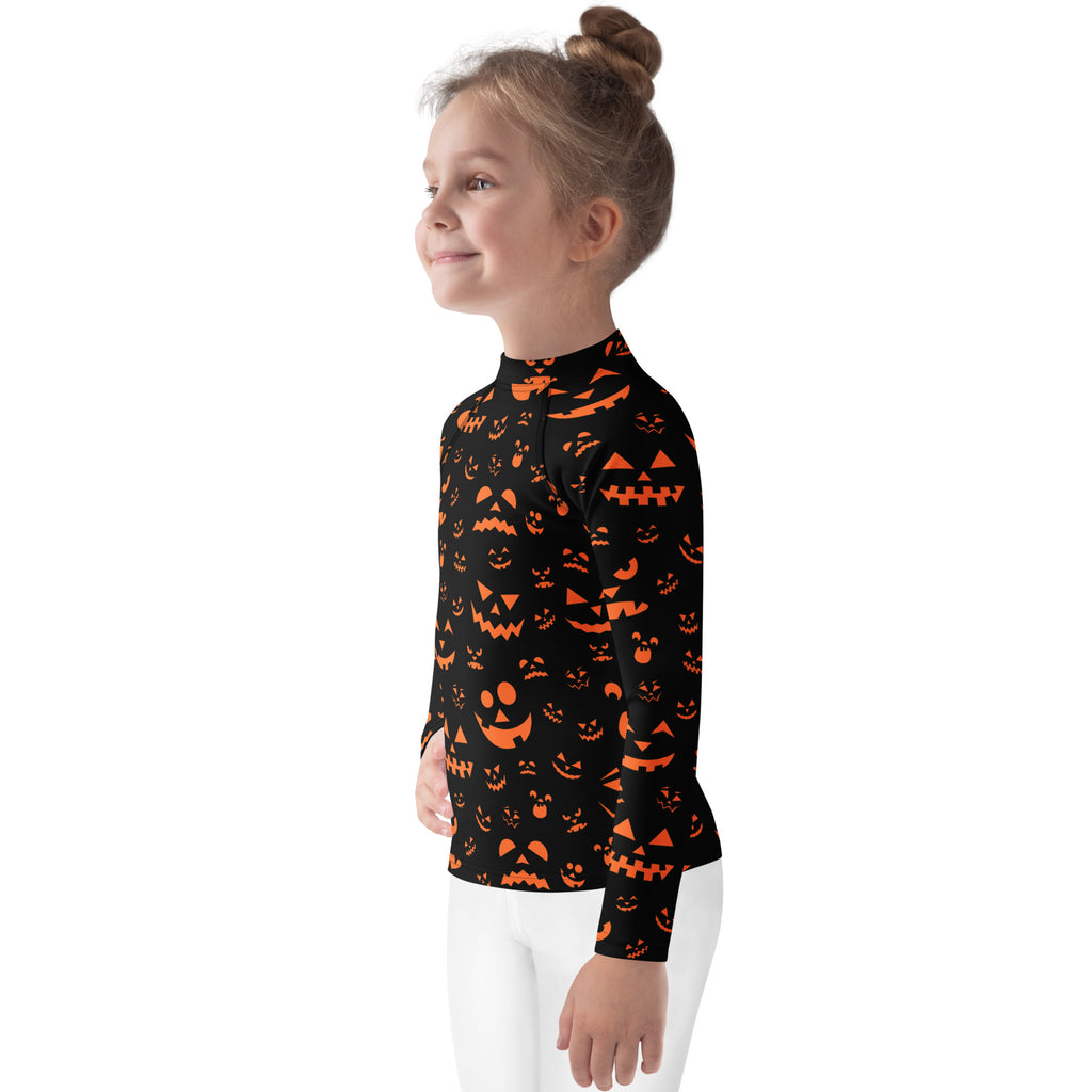 Black long-sleeved halloween rash guard with orange jack-o-lantern faces and upf 50+ for kids swimwear