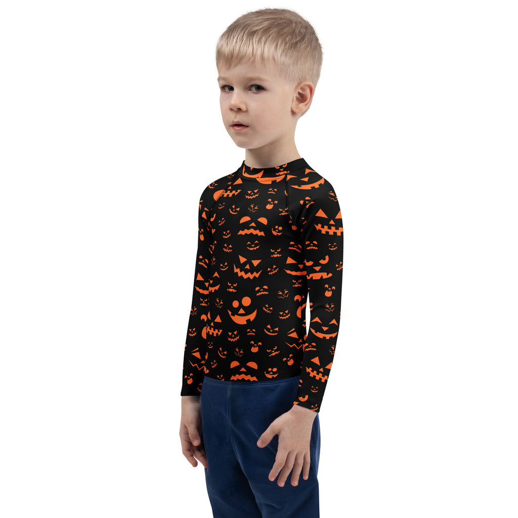 Kids black long sleeve rash guard swim shirt with orange jack-o-lantern faces and upf 50 plus for halloween