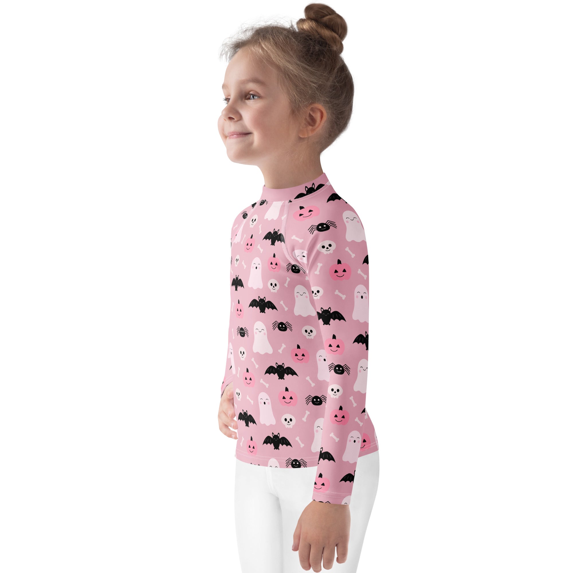 Girls pink long sleeve rash guard swim shirt with playful black and white halloween ghosts bats spiders and pumpkins pattern