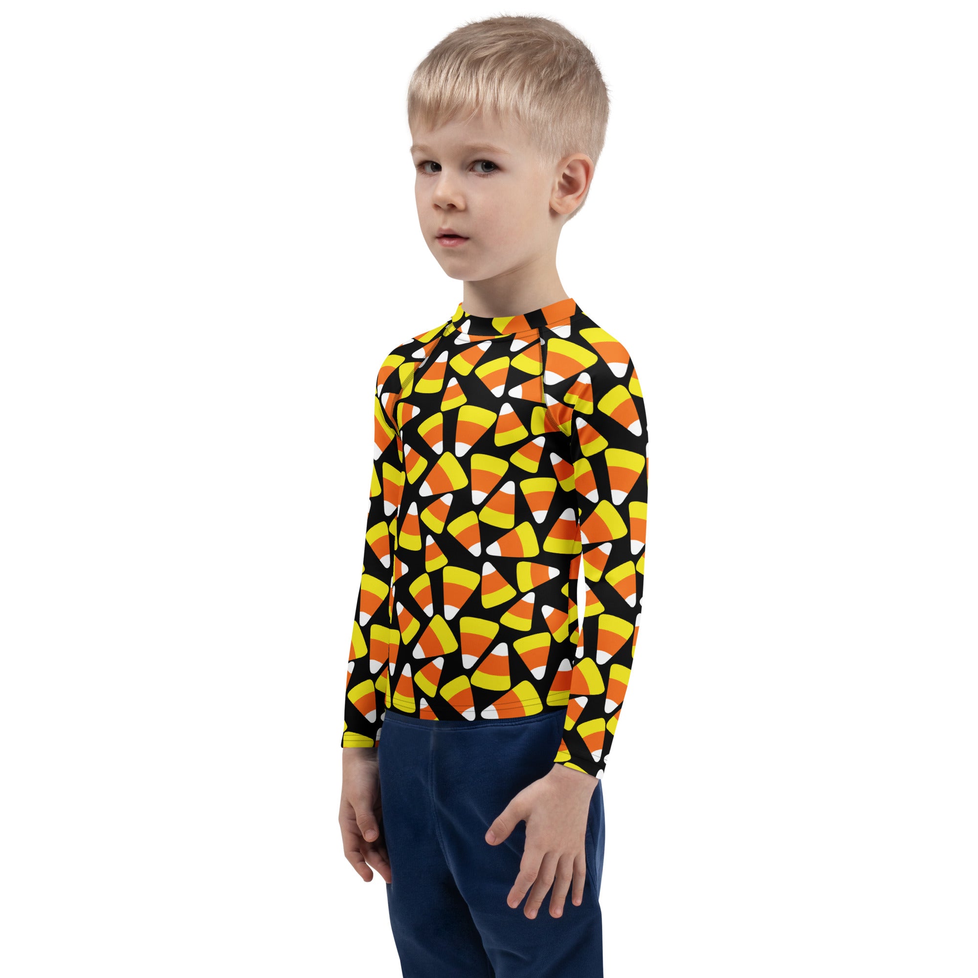 A child wearing a black kids candy corn Halloween long sleeve rash guard swim shirt with UPF 50 plus protection