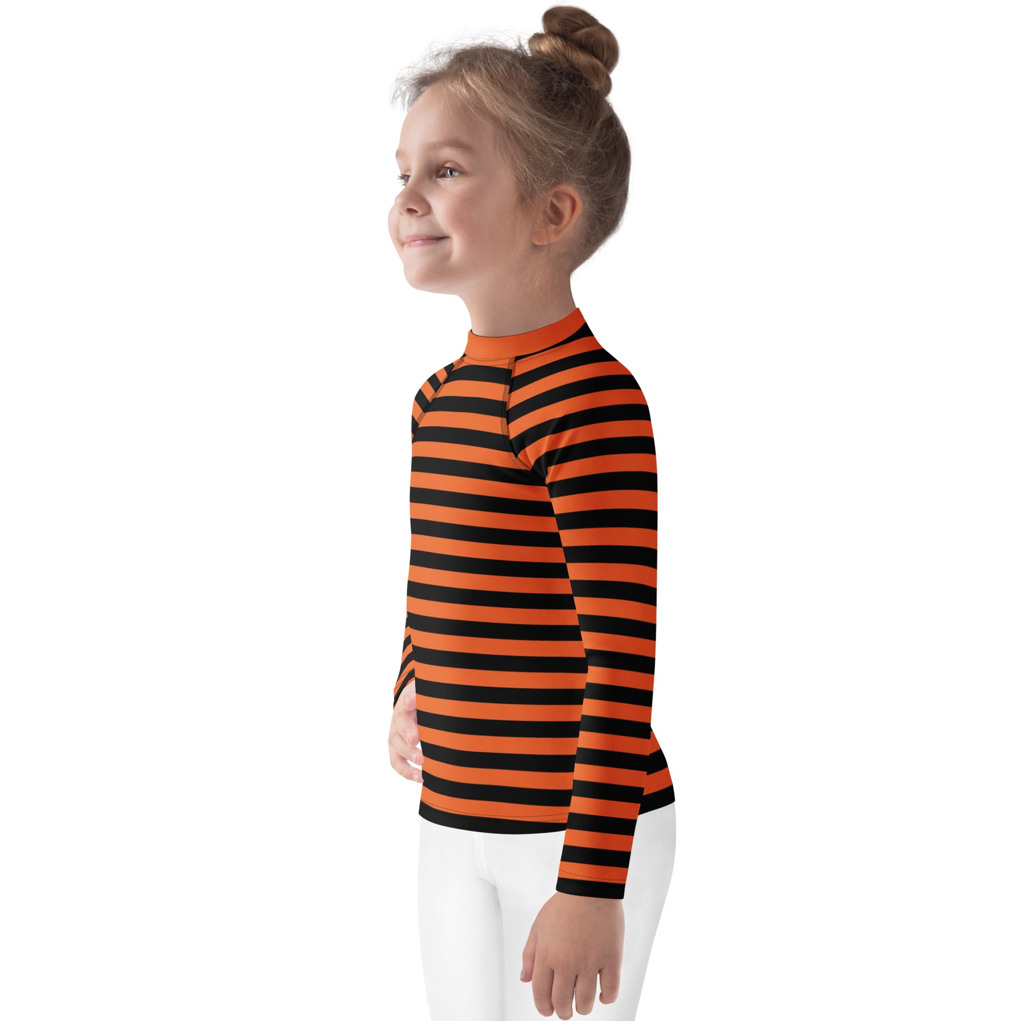 A child wearing a kids orange and black halloween long sleeve rash guard swim shirt with upf 50 plus and high collar