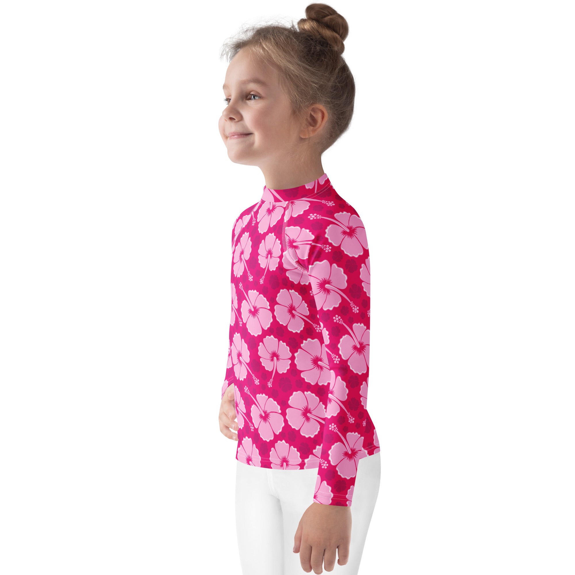 A girls tropical pink long sleeve rash guard with a light pink hibiscus pattern and UPF 50+ sun protection