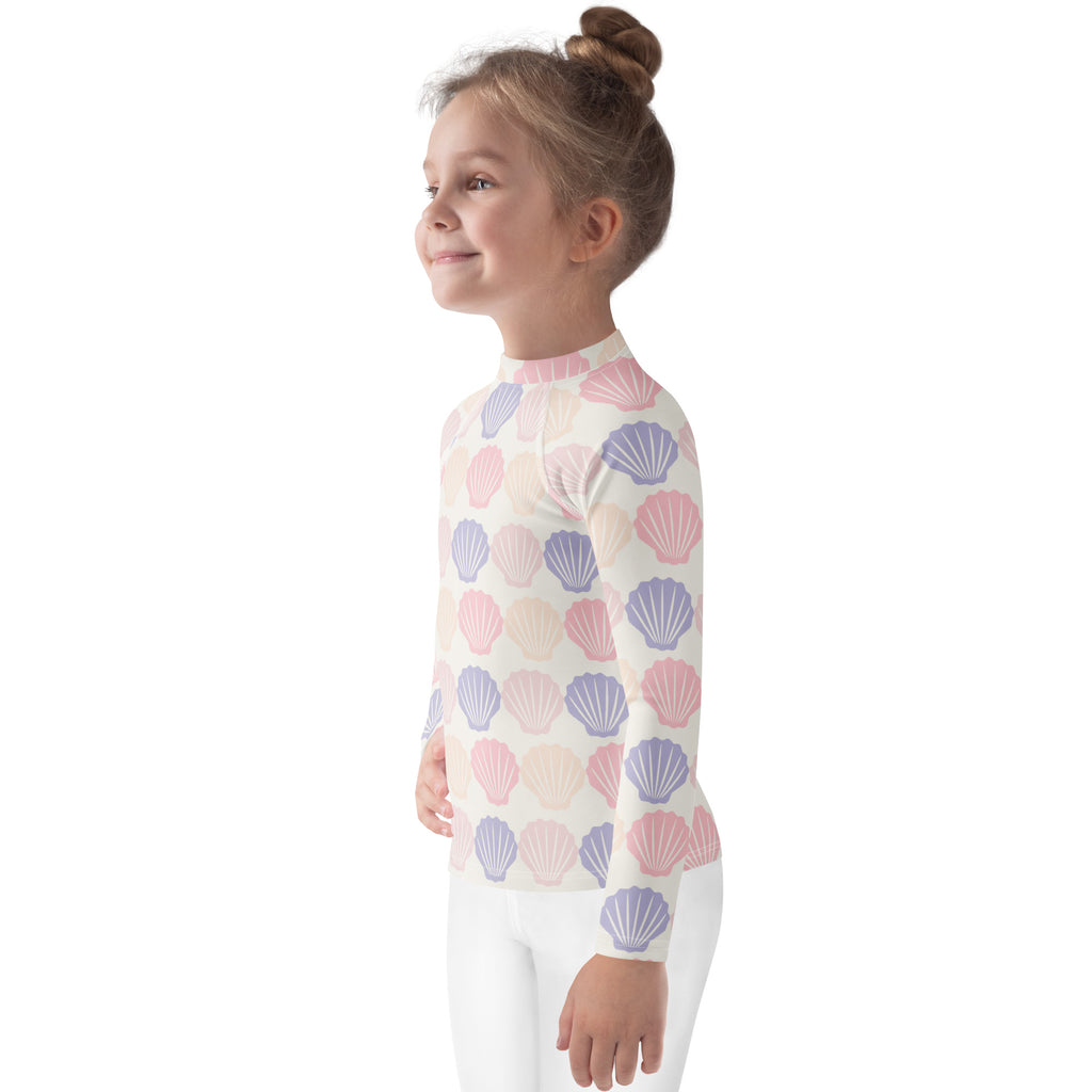 Kids seashell print long sleeve rash guard swim shirt with upf 50 featuring pastel pink and lavender seashells on off-white