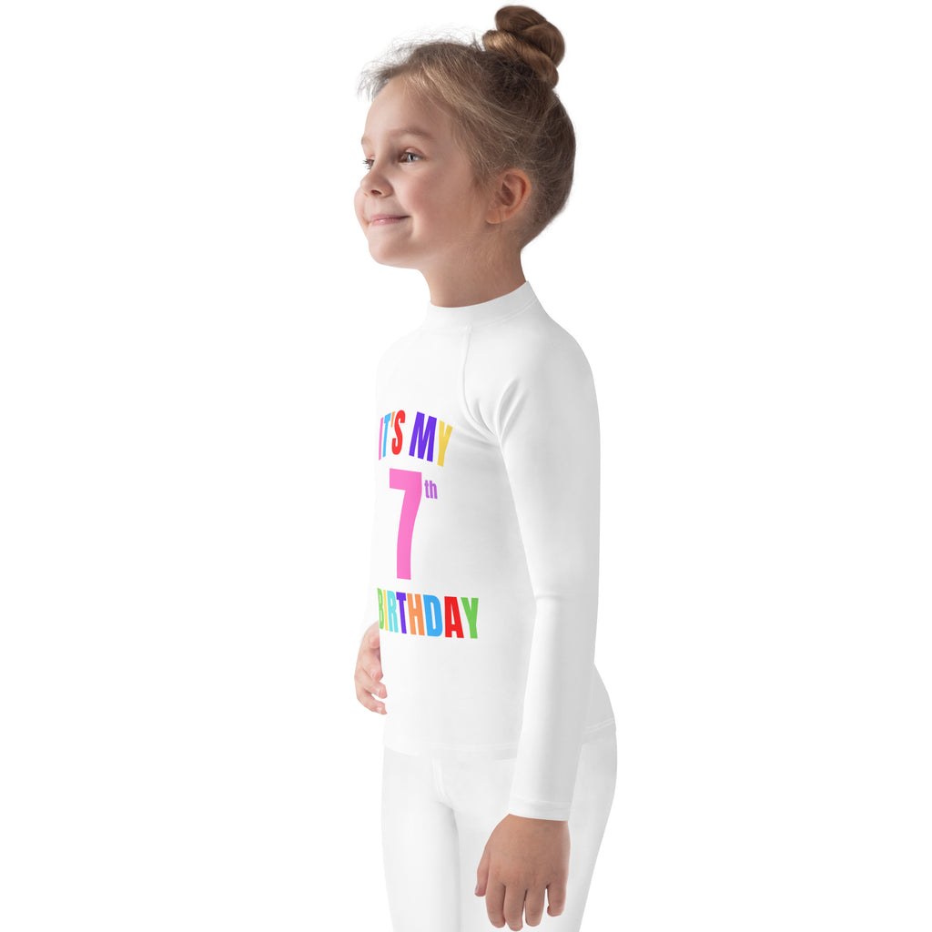 White long-sleeved kids custom age rash guard swim shirt with its my 7th birthday rainbow print and upf 50+ protection