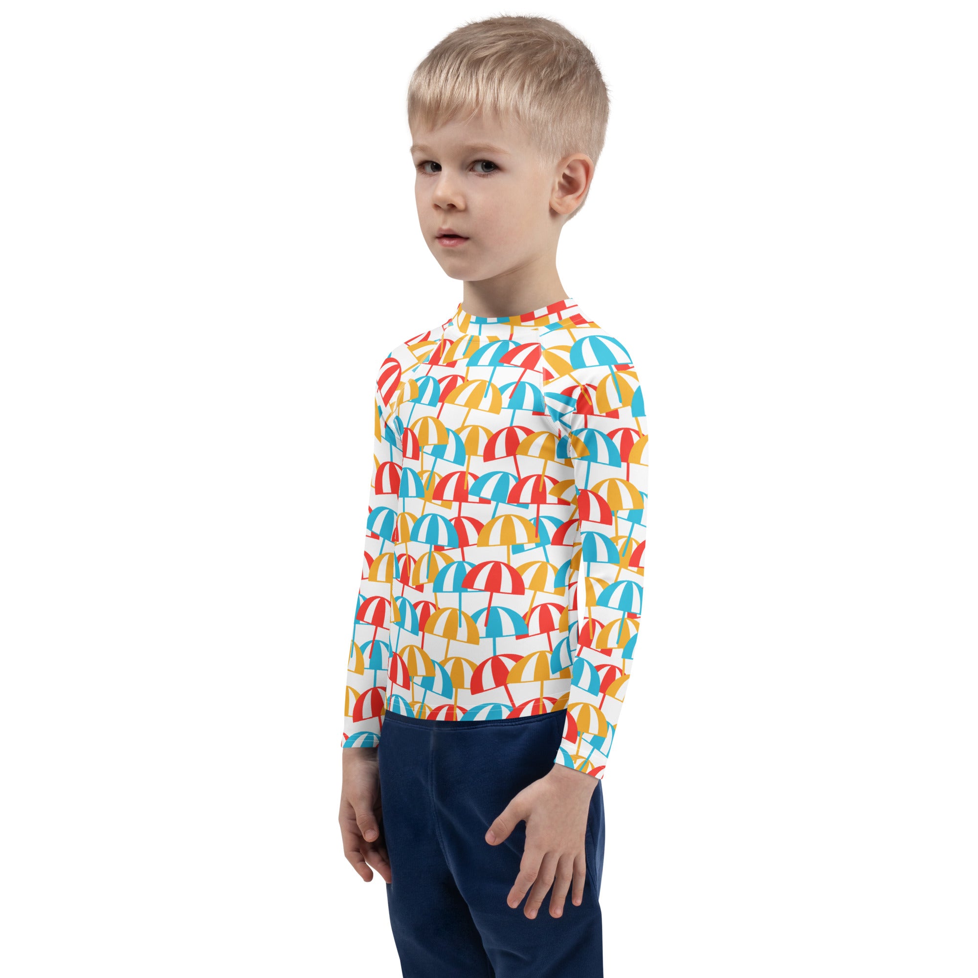 A child wearing a kids beach umbrella long sleeve rash guard swim shirt with colorful umbrella pattern and UPF 50+ protection