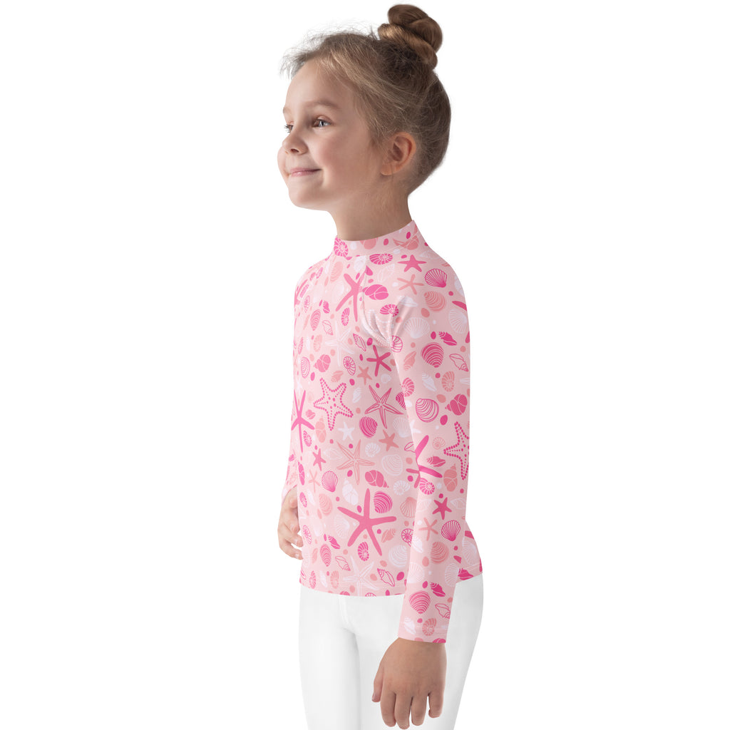 Girls pink long sleeve rash guard swim shirt with playful starfish and seashell pattern and upf 50 plus protection