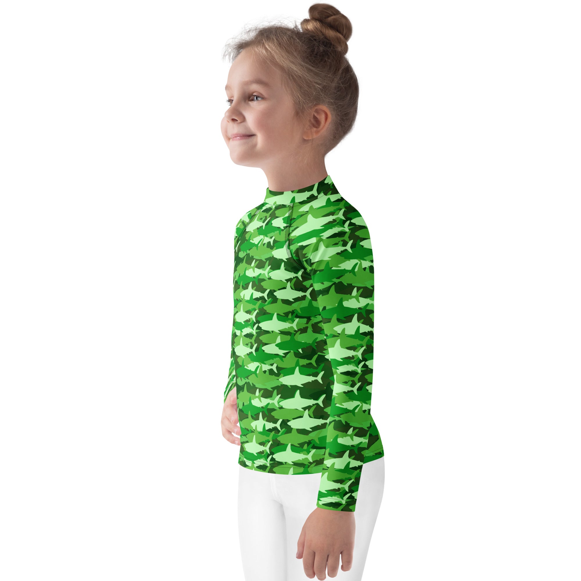 A child wearing a kids green shark long sleeve rash guard swim shirt with upf 50 plus and green camouflage pattern