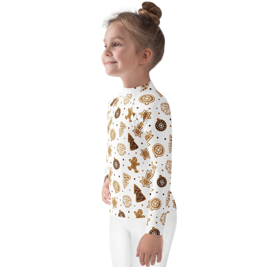 A child wearing a white kids gingerbread cookies christmas long sleeve rash guard swim shirt with upf 50+