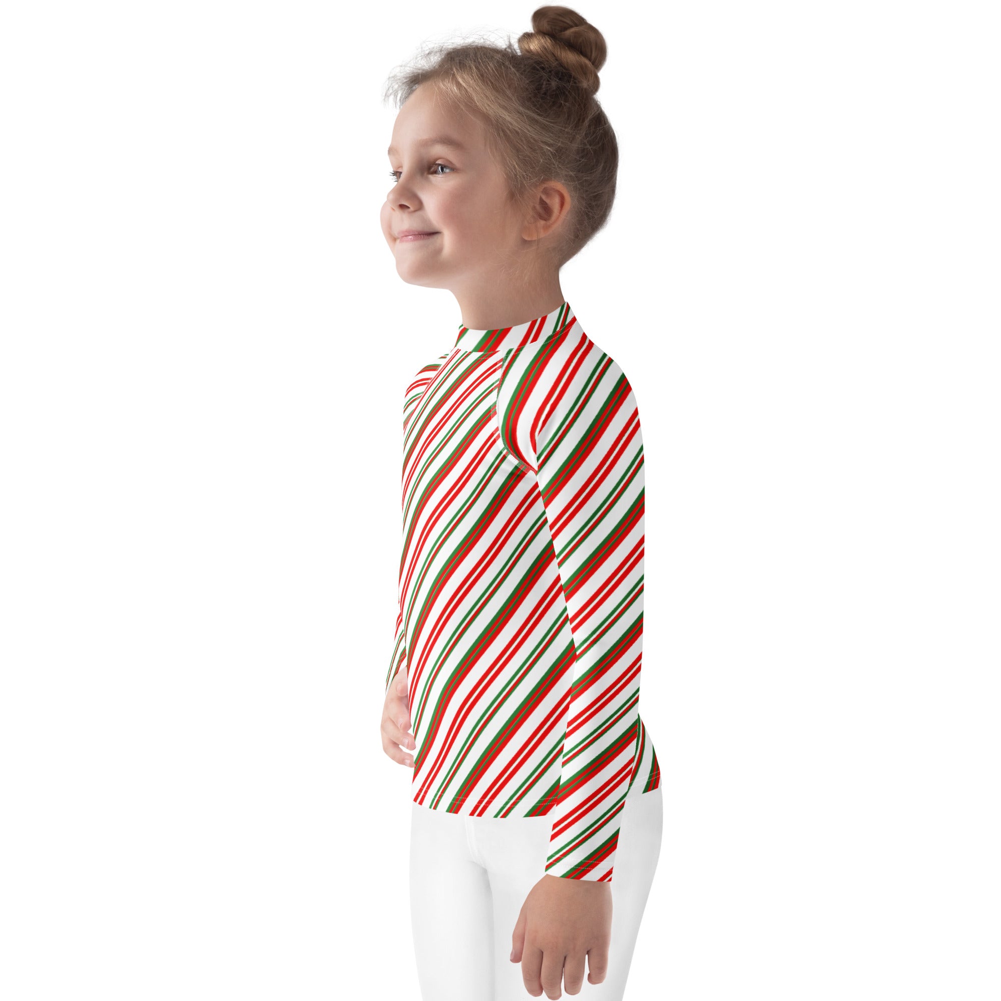A child wearing a kids candy cane stripe Christmas long sleeve rash guard swim shirt with UPF 50+ and diagonal red green and white stripes